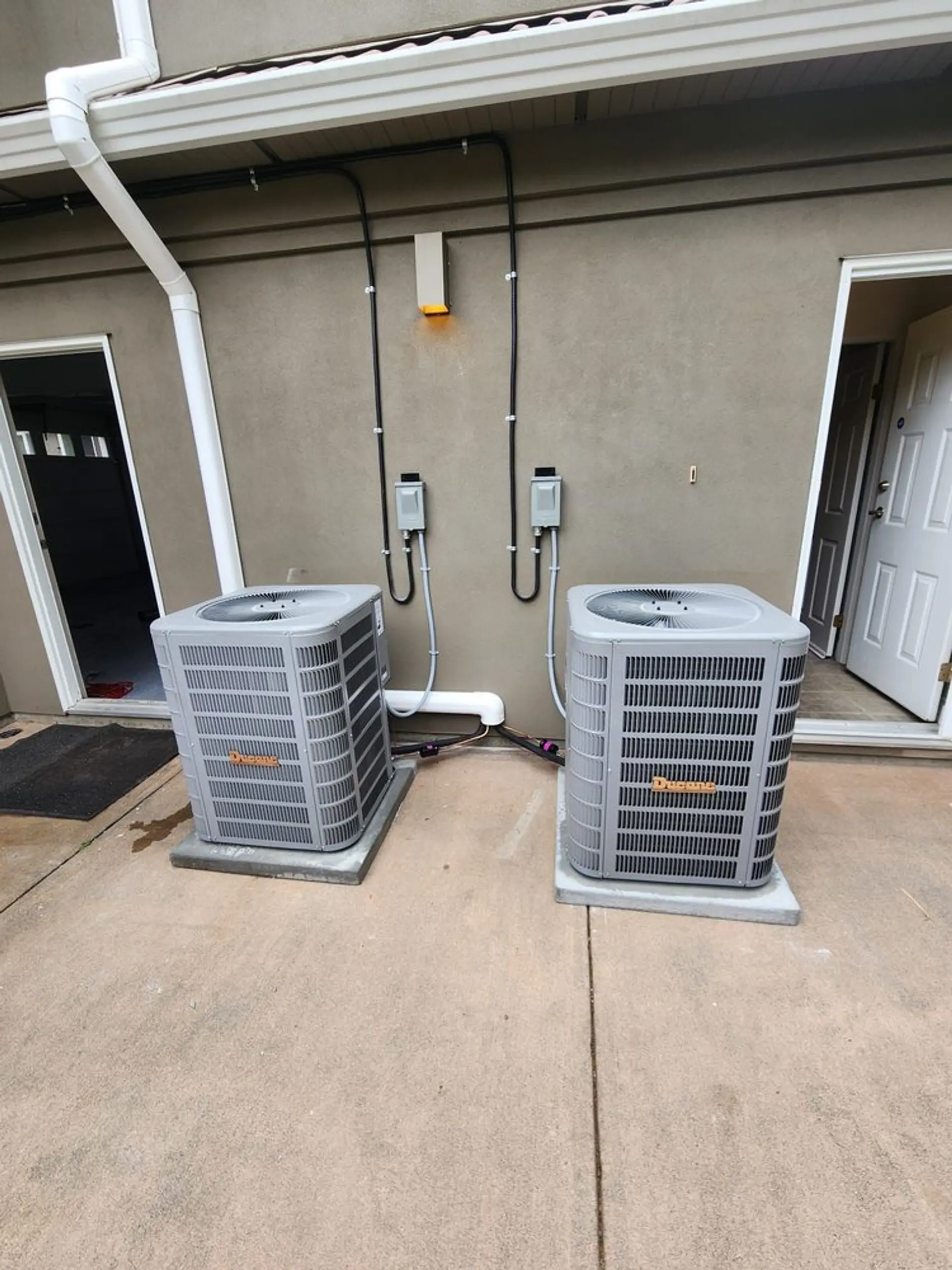 Outdoor condenser units installed beside a Vancouver home