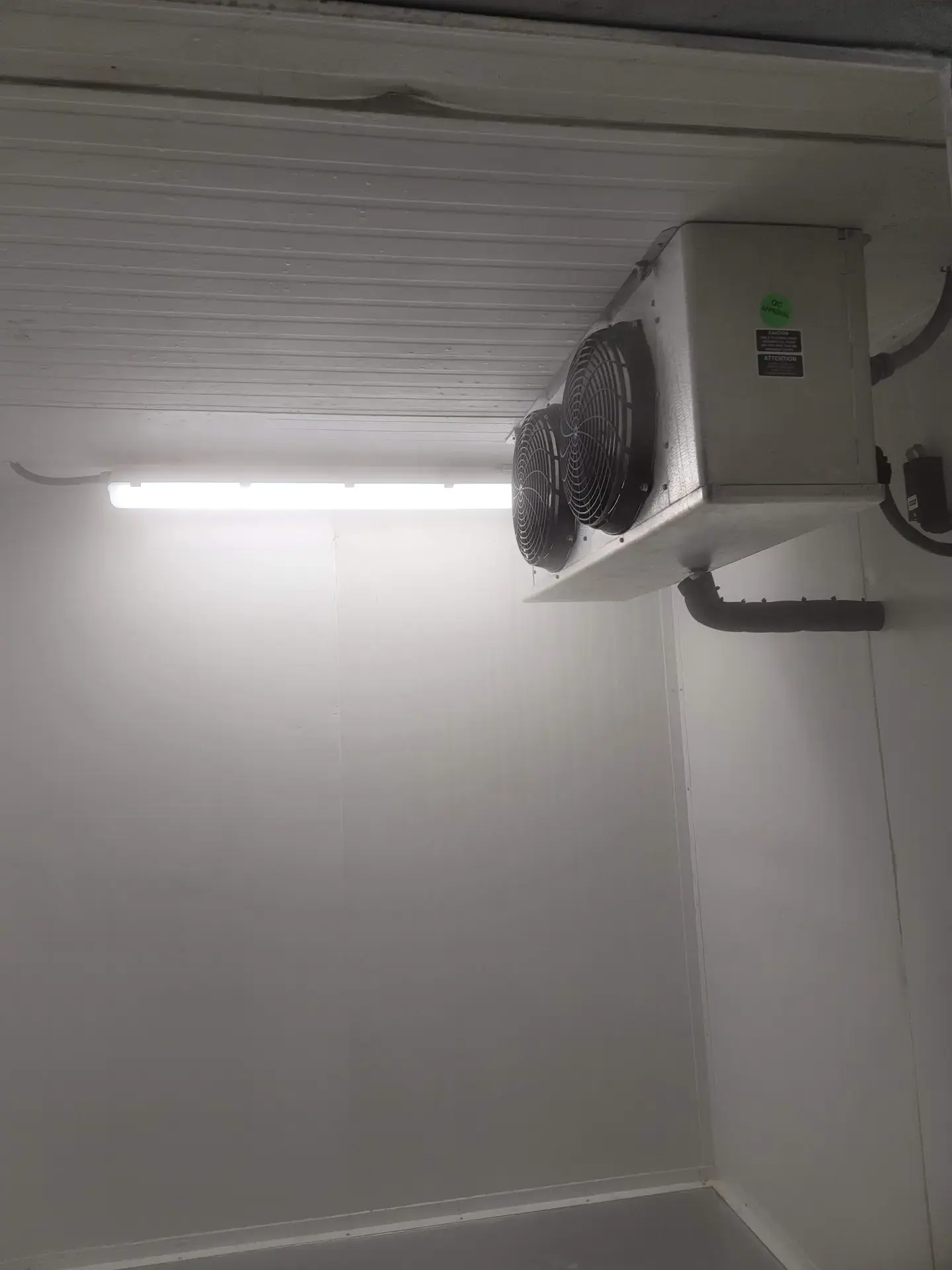 Evaporator unit inside a commercial walk-in cooler in Metro Vancouver