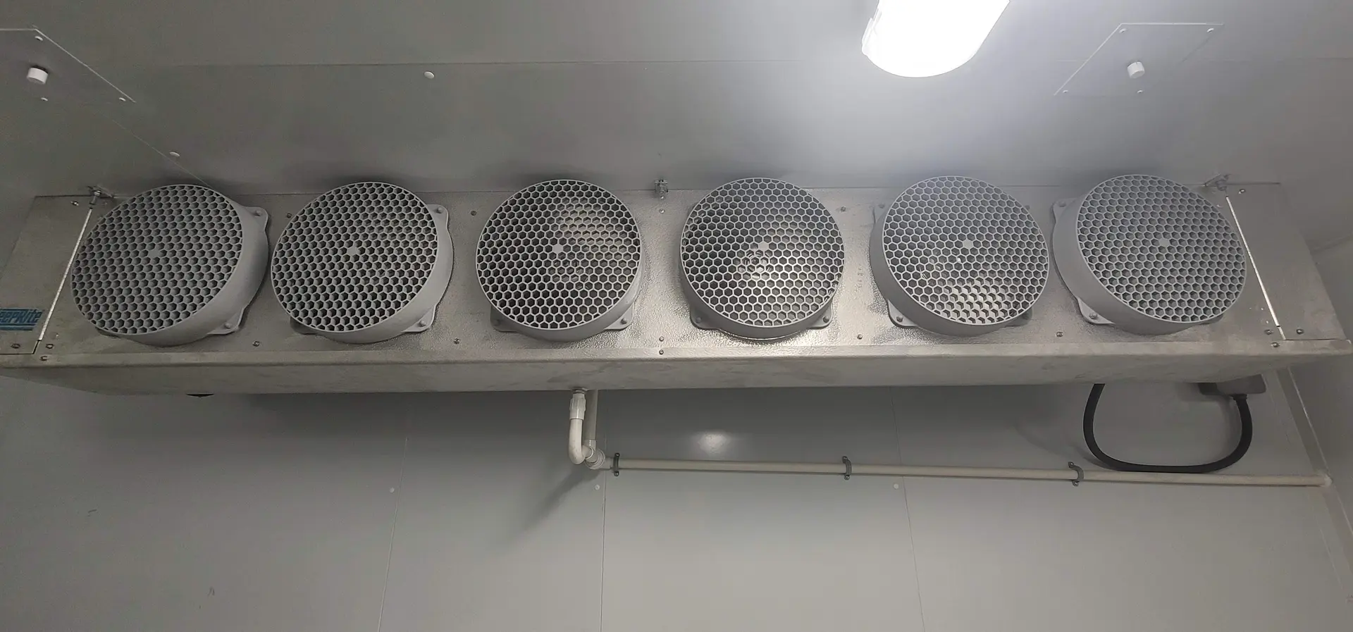 6-fan evaporator unit inside commercial walk-in cooler installed by Air Comfort Systems